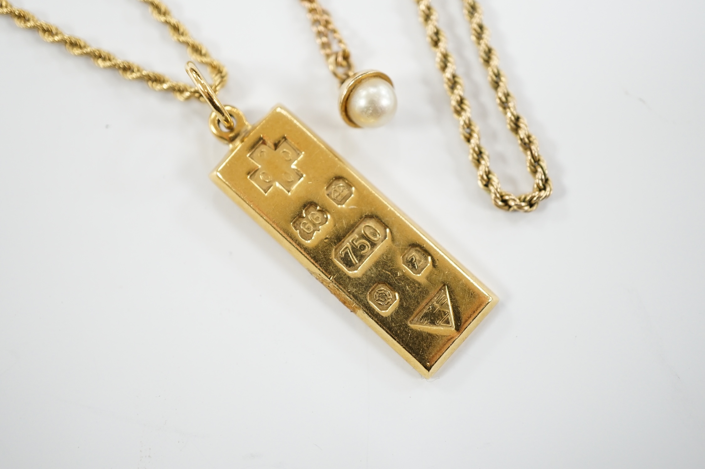 An 18ct gold ingot pendant on an 18k chain, 26.7 grams and two 9ct chains, one with cultured pearl pendant, gross weight 16.8 grams.